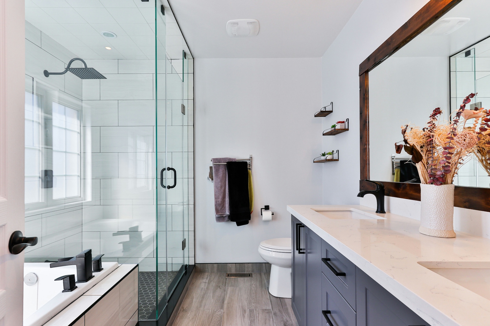 Bright modern bathroom with glass shower and stone vanity